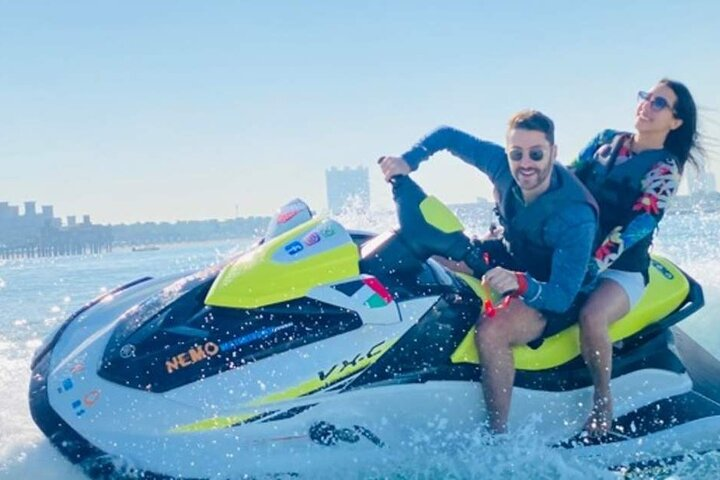 Experience the excitement of gliding across the Arabian Gulf on a Jet Ski taking in stunning views of Dubai's skyline while creating unforgettable memories with friends.